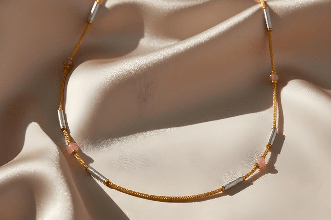 A delicate necklace resting on soft fabric