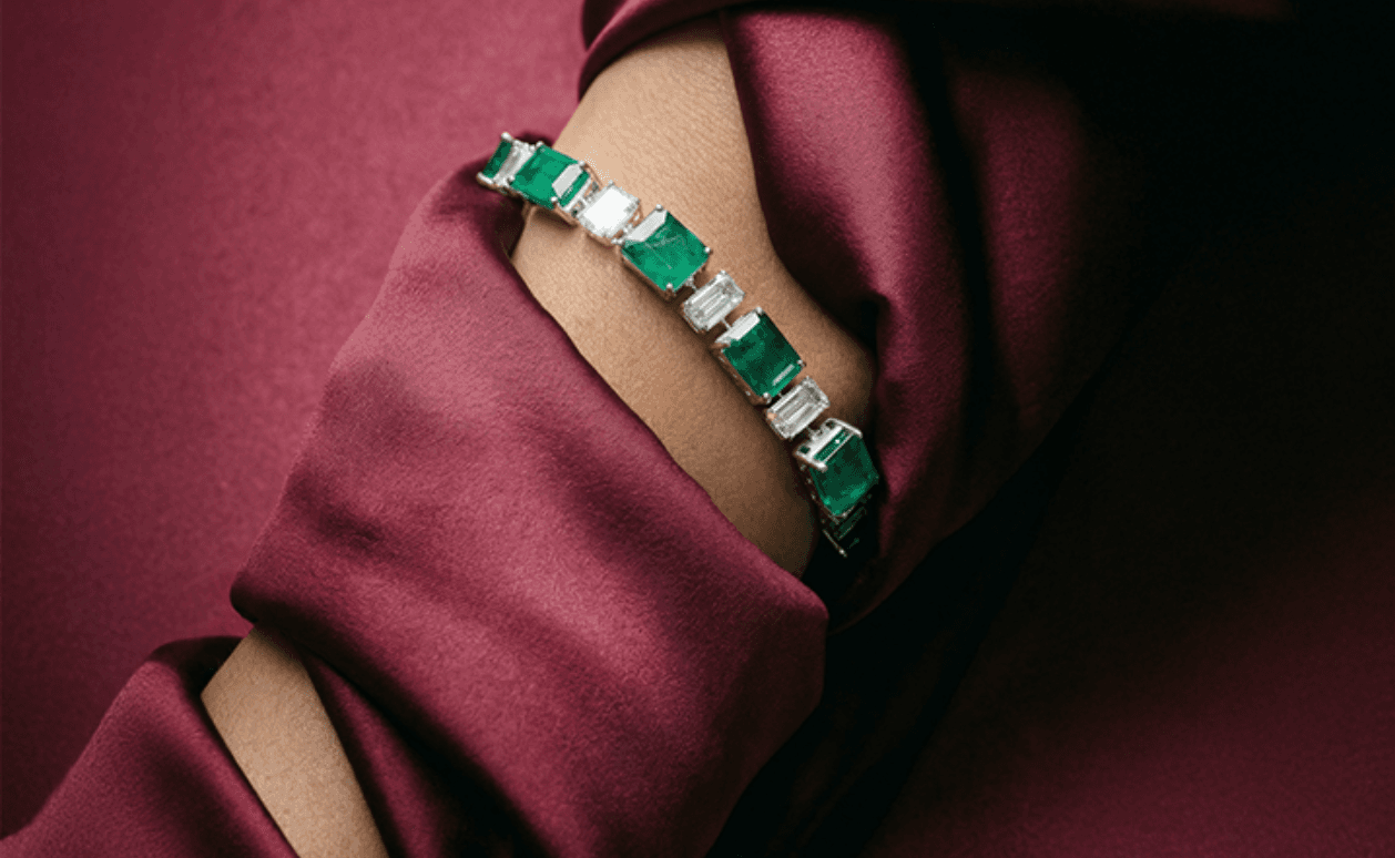 An emerald bangle worn on a wrist